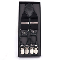 A pair of black Orobianco L'unique suspenders with gray detailing, presented in a black box with the brand's logo on the top.