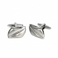 Pair of silver cufflinks on a white background