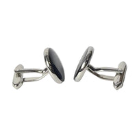 Pair of silver oval cufflinks on a light gray background