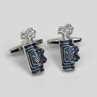A pair of Golf silver cufflinks shaped like stacked blue and white enamel cups, photographed on a light gray background.