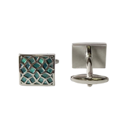 Pair of square cufflinks with one having a geometric pattern and the other plain, on a light gray background.
