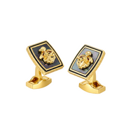 Gold cufflinks with a black square design on a light gray background
