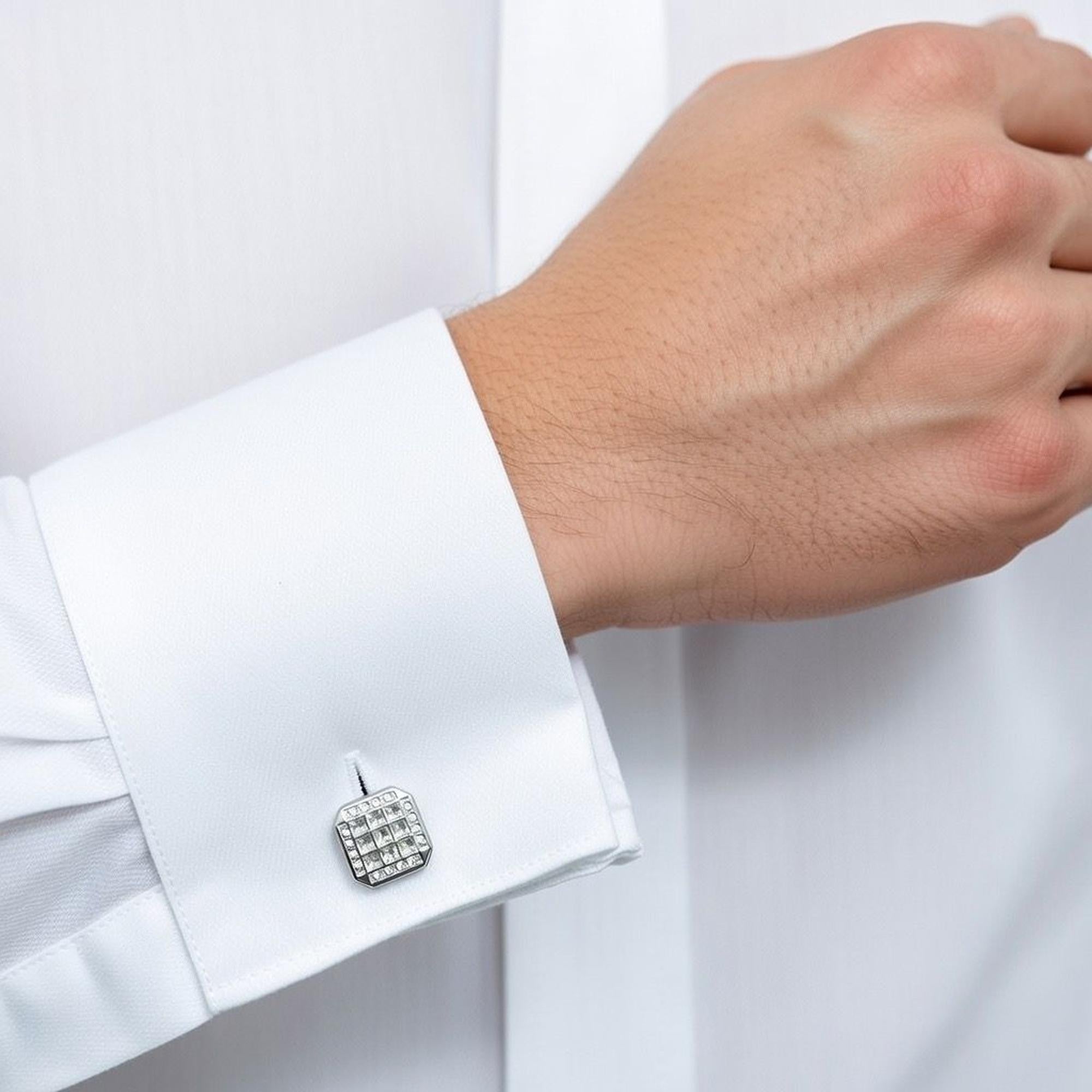 Cufflink on a white shirt cuff with a white background