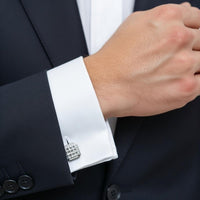 Close-up of a suit cuff with a decorative cufflink